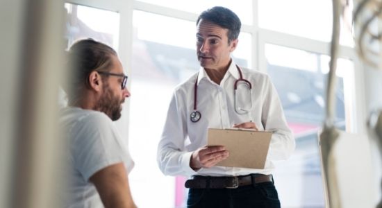 Doctor talking to a patient with a clipboard